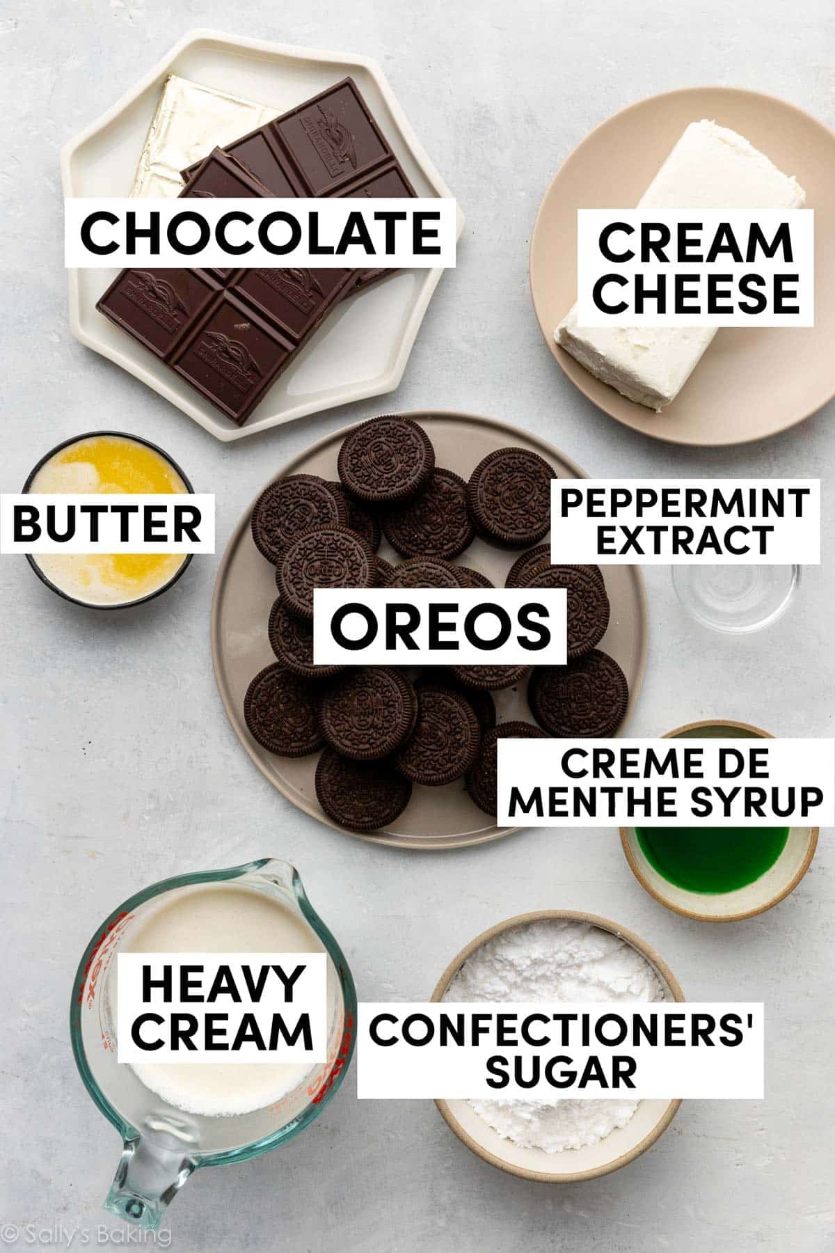 ingredients in bowls including peppermint extract, heavy cream, confectioners' sugar and Oreos.