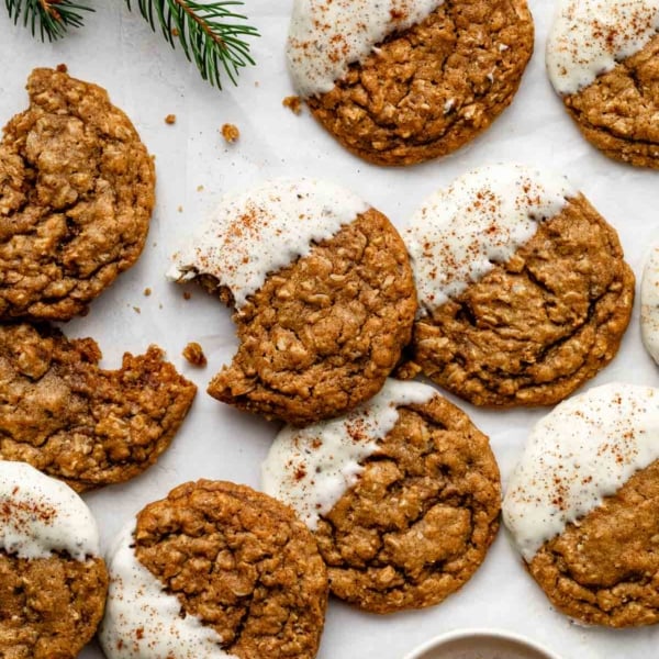 white chocolate dipped gingerbread latte cookies with cinnamon sprinkled on top.
